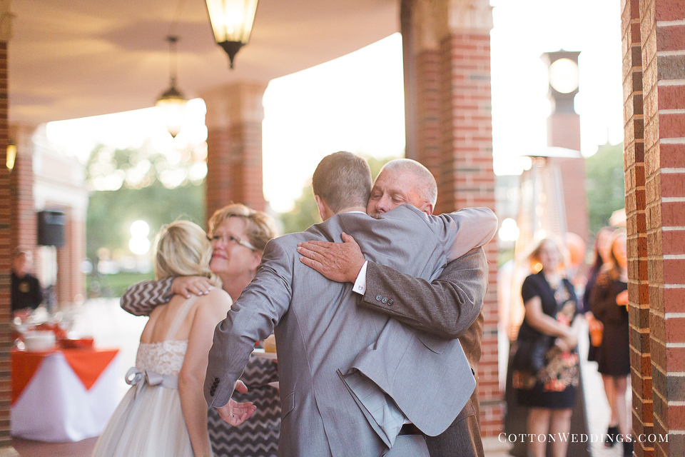 bride groom hugging parents
