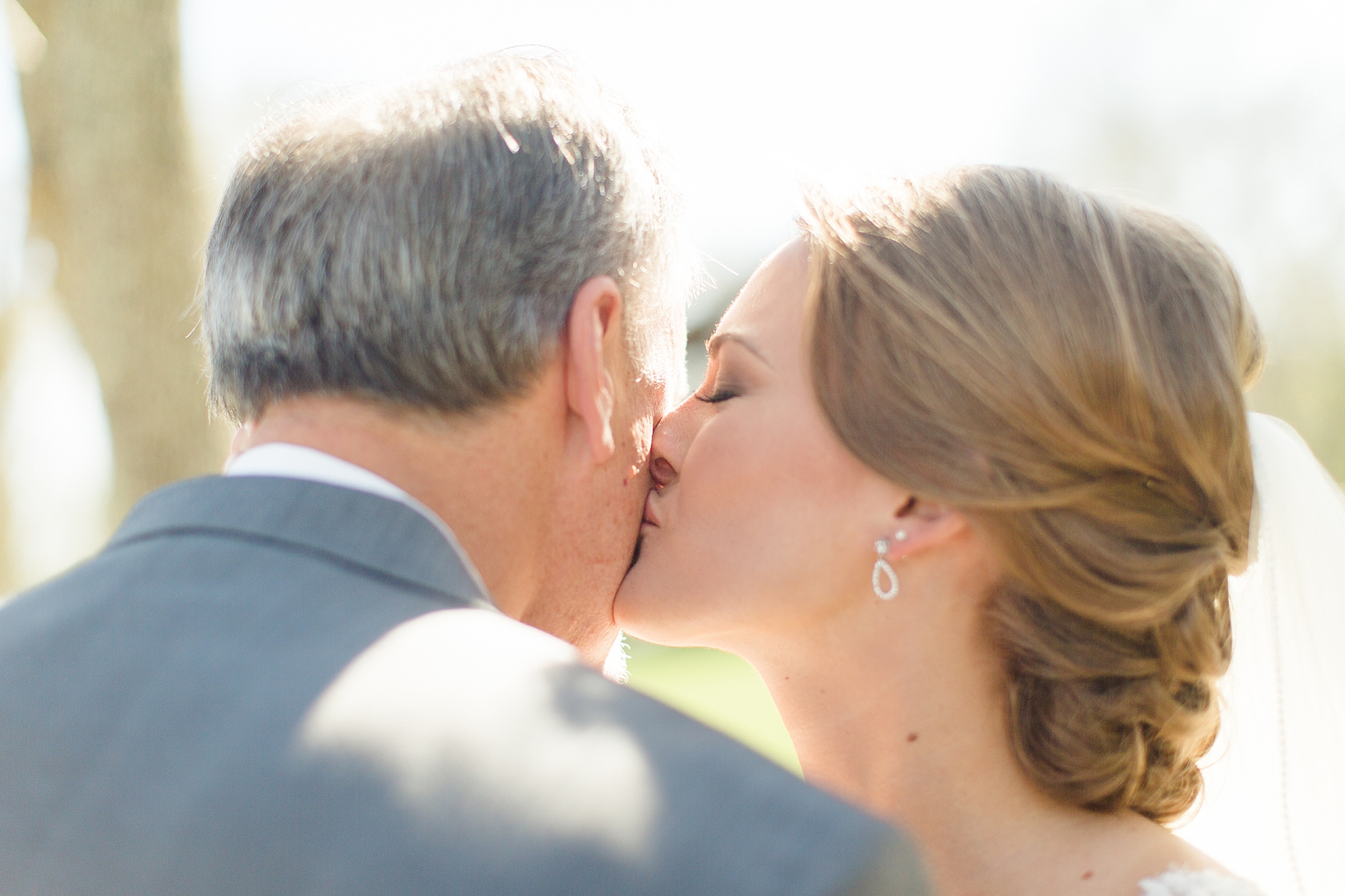 bride kissing dad on cheek