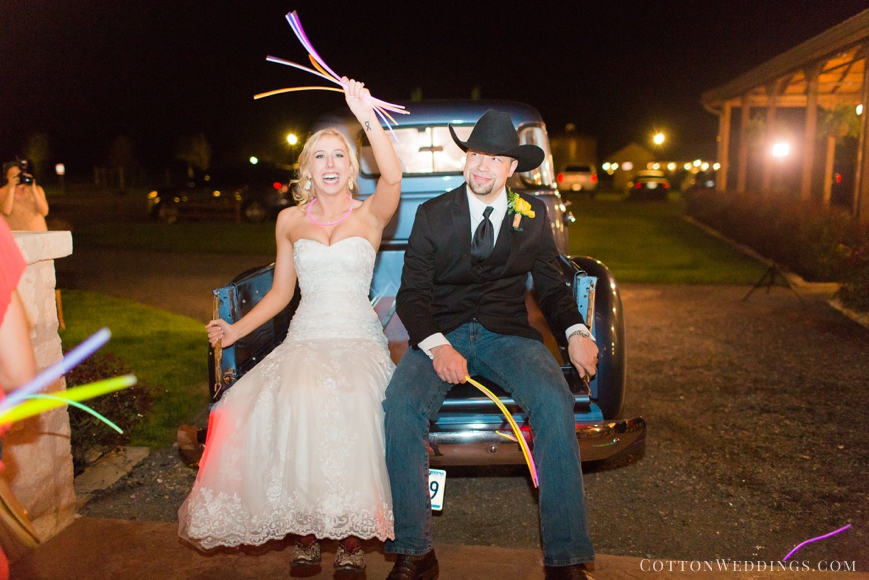 bride and groom in back of truck exit