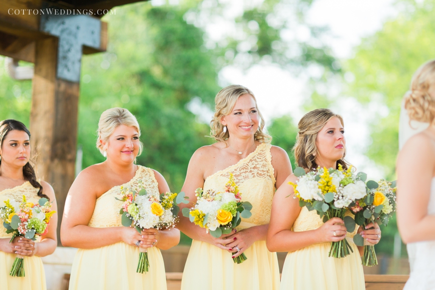 bridesmaids smiling at couple during ceremony