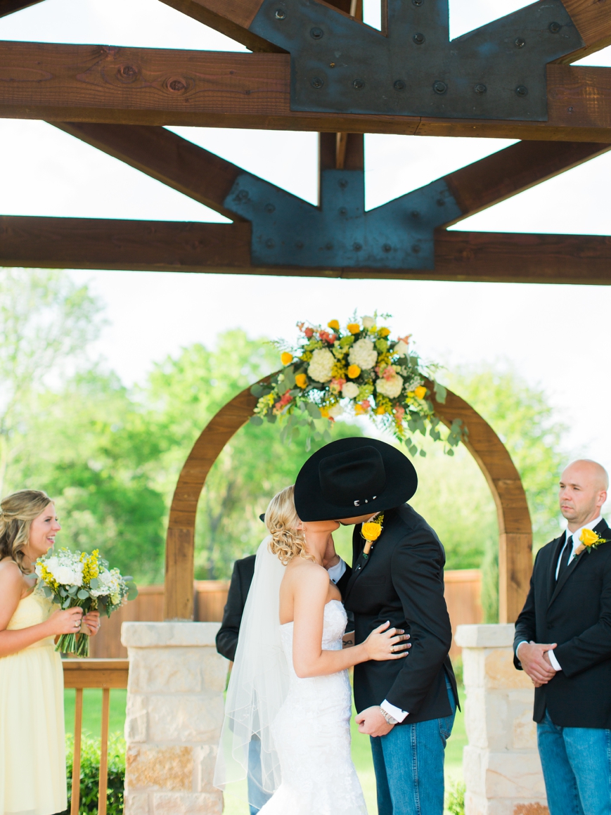 country outdoor wedding ceremony first kiss
