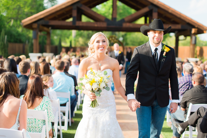 country outdoor wedding couple walking back down aisle