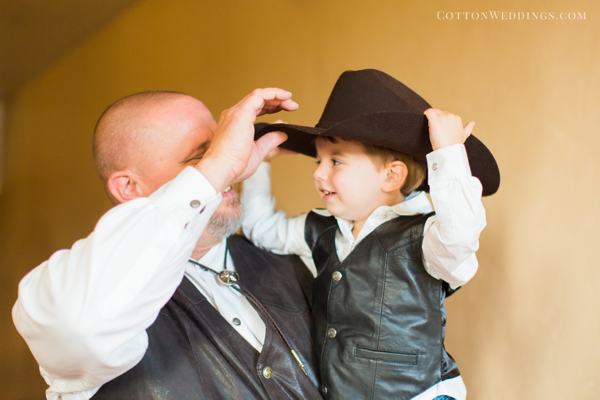 ring bearer boy trying on grandpa's hat
