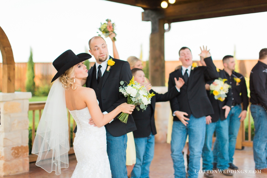 bride wearing groom's cowboy hat