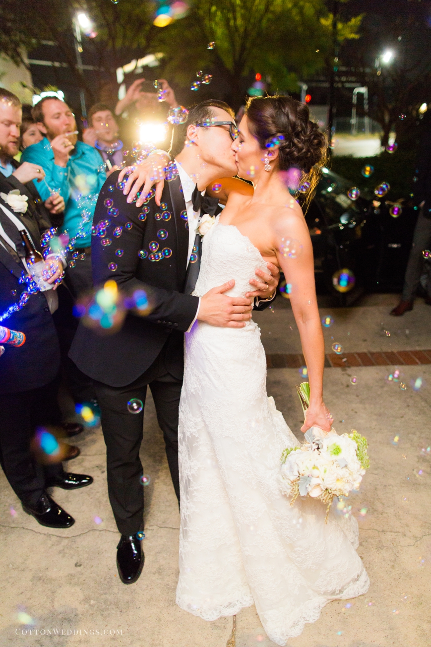 bride and groom kissing bubble exit