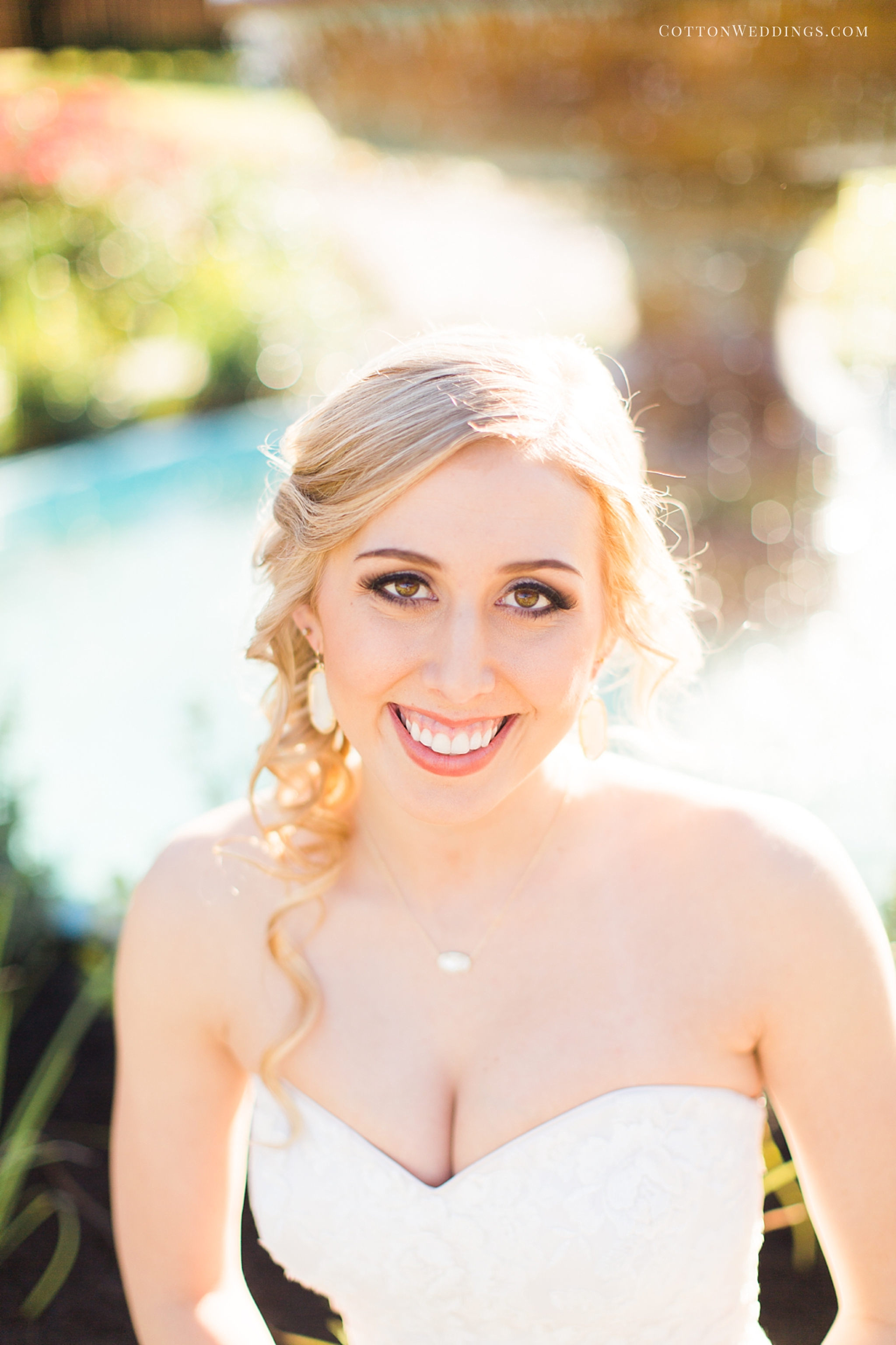 beautiful blonde bride by fountain