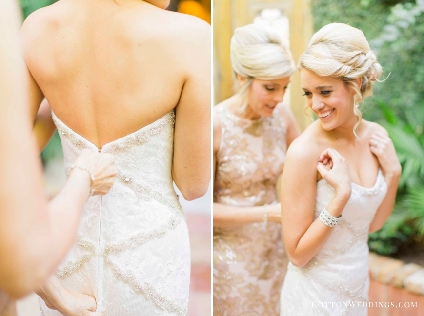 mother putting bride in her dress