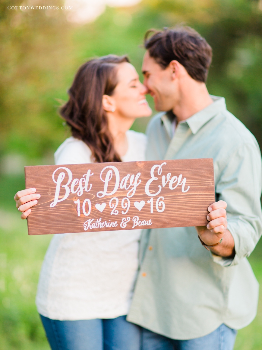 cute couple kissing with best day ever custom save the date sign