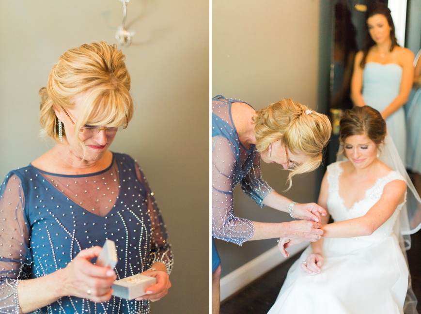 mom crying putting on grandmother's pearl bracelet on bride