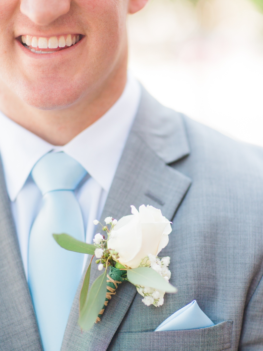 detail of white rose boutonniere 