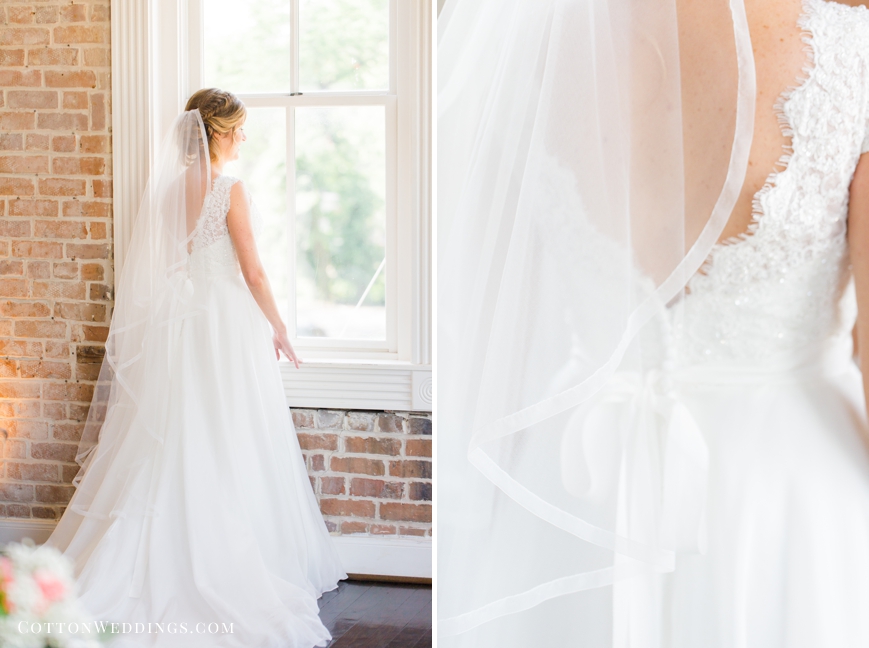 bride standing by window portrait