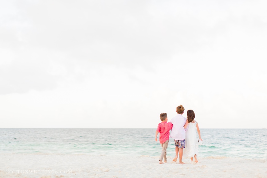 adorable photo of little girl and boys walking on the beach