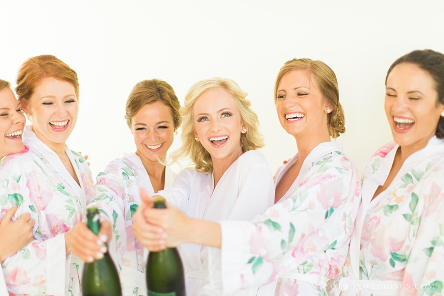 bride pop champagne bottle with bridesmaids