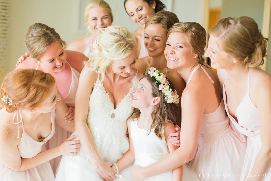 adorable photo of bride hugging flowergirl and bridesmaids
