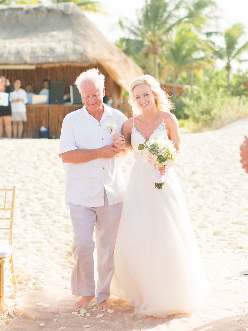 bride and father walking down the aisle at beach wedding
