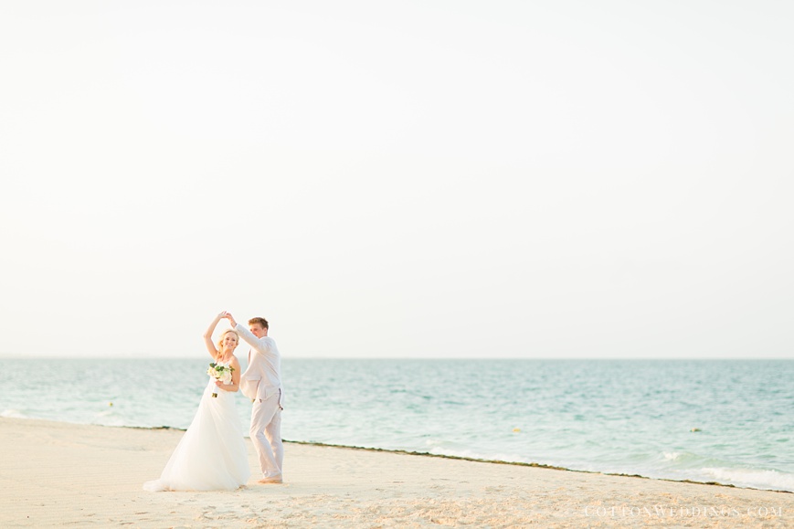 beautiful portrait of bride and groom dancing on beach