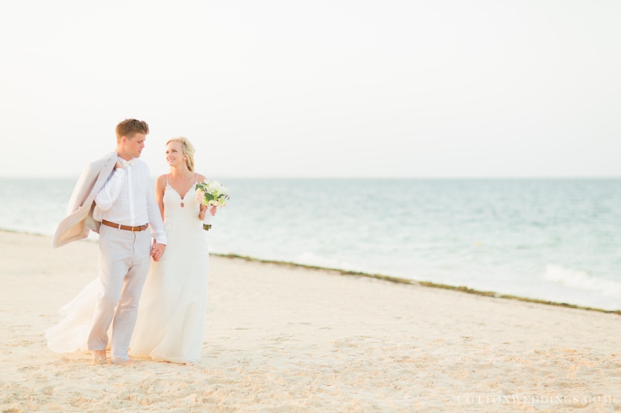beautiful bride and groom walking on beach
