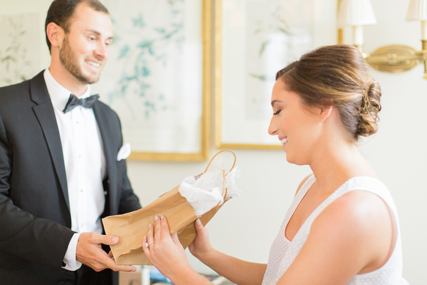 brother giving bride a gift from groom