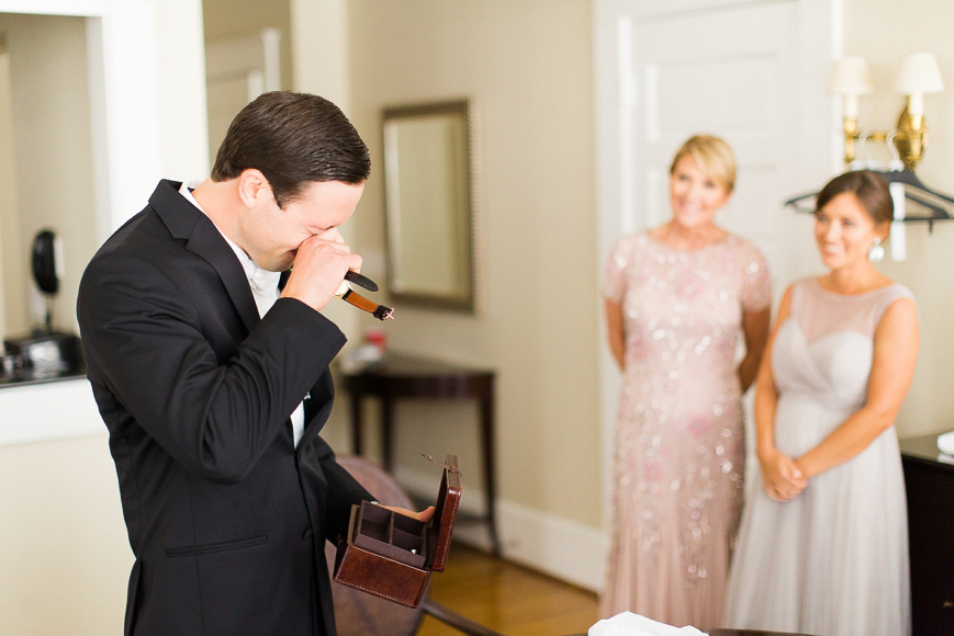 groom crying opening gift from bride