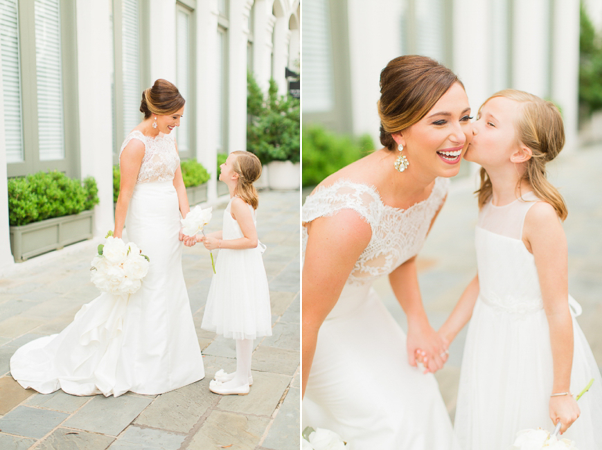 bride with adorable flower girl kissing on the cheek