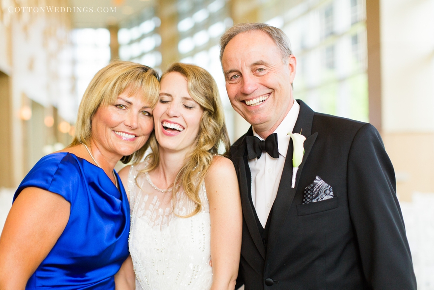 bride laughing with mom and dad