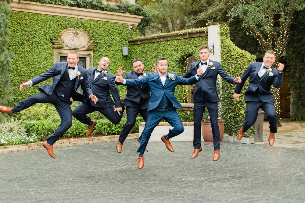 groom and groomsmen jumping 