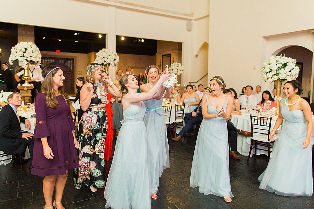 bridesmaids catching bouquet toss