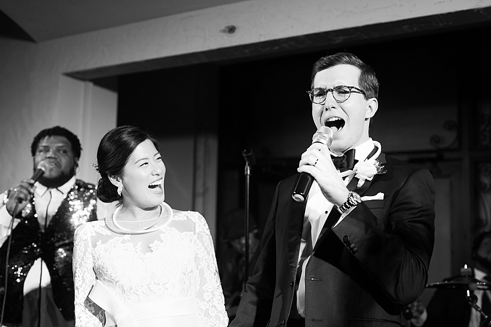 groom singing to bride at the bell tower
