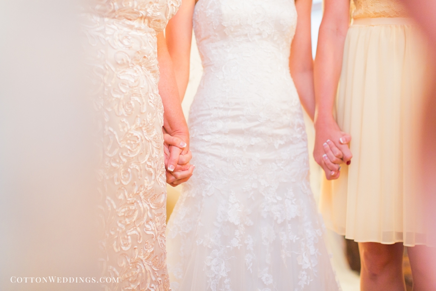 bride holding hands with mom and sister