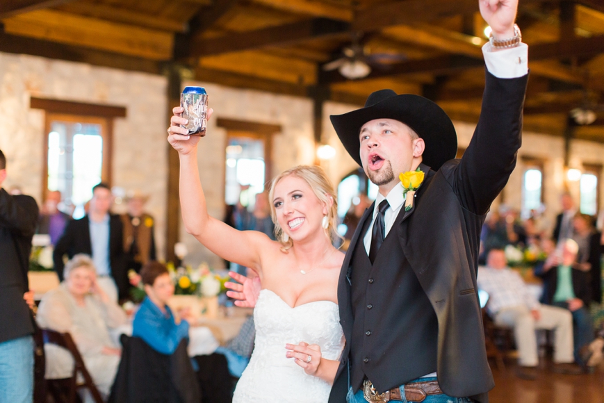 bride and groom toast with beers