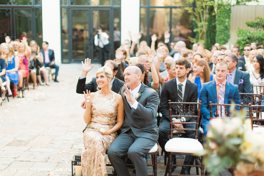 friends and family raise hands in love during ceremony