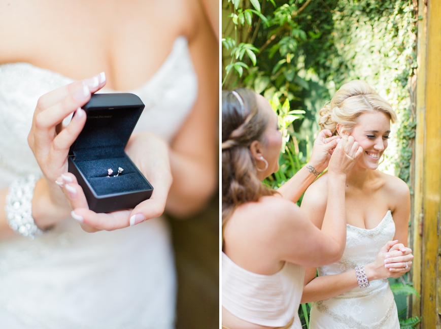 maid of honor putting in diamond earrings for bride