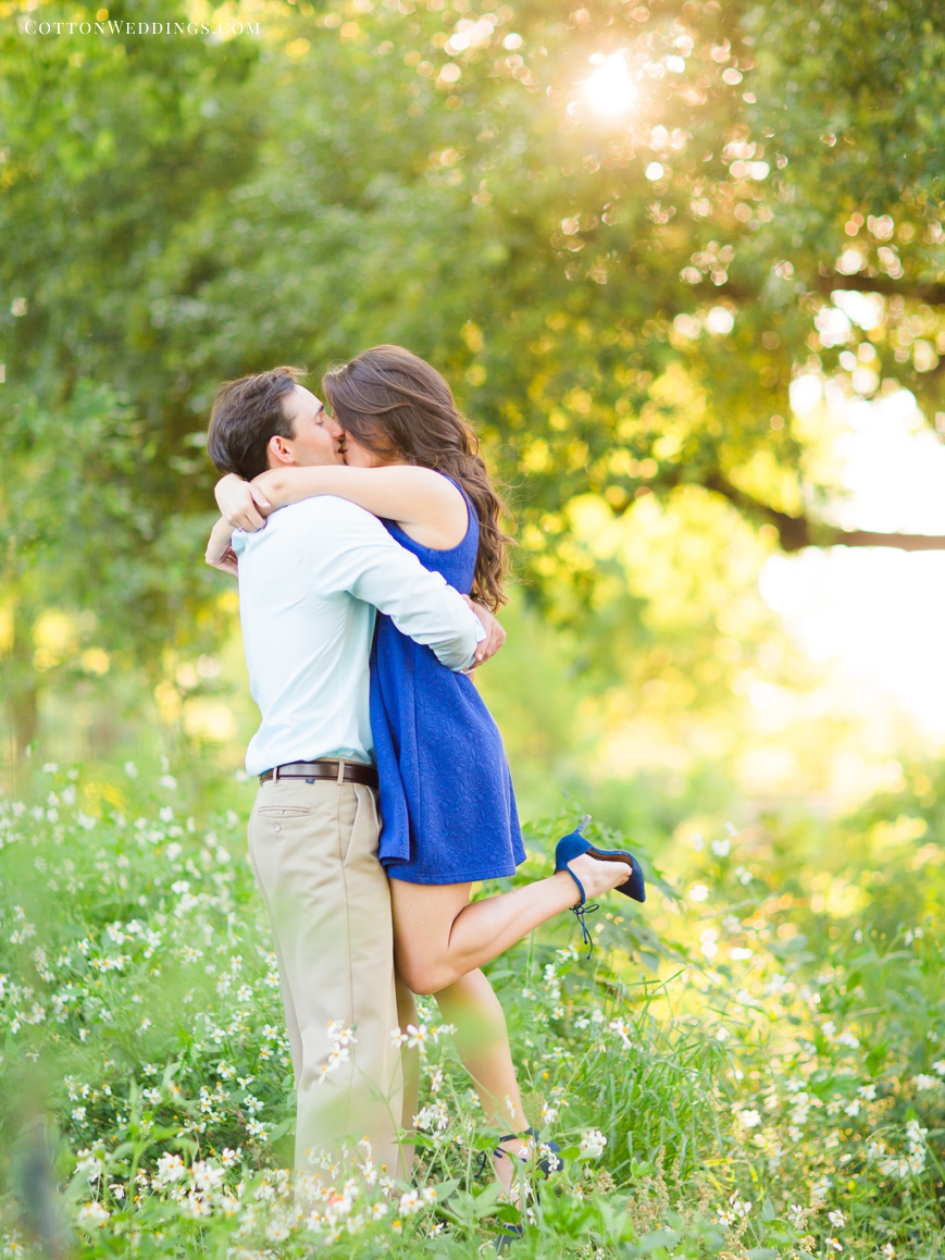 engaged couple hugging sweetly in wildflowers