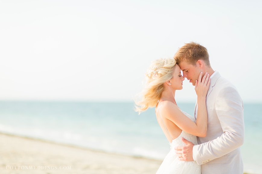 airy sunny light portrait of bride and groom on beach