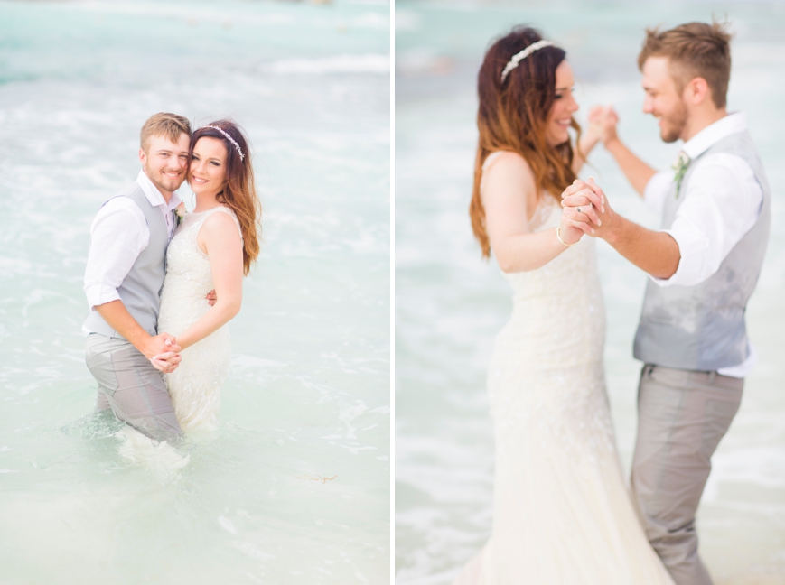 bride and groom playing in ocean