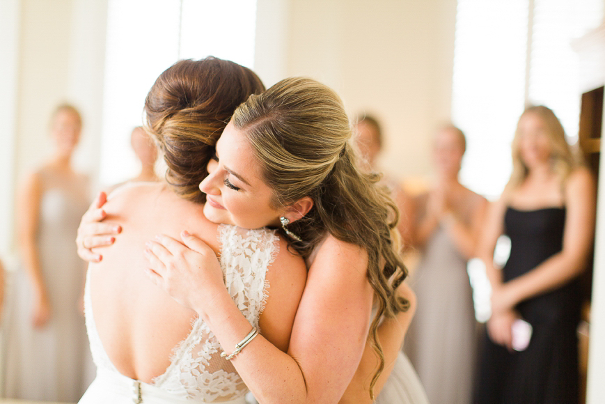 bridesmaid hugging bride