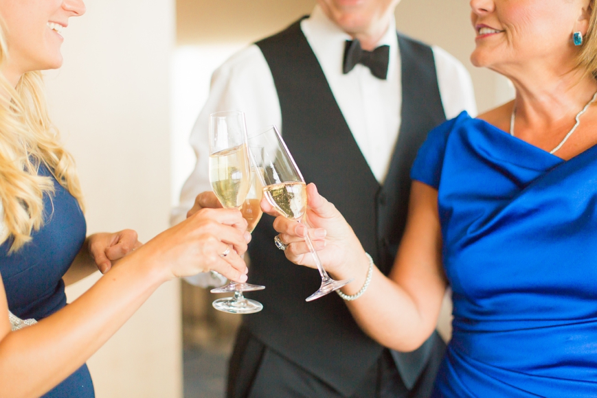 family cheers champagne before wedding
